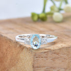 7x5mm Oval Blue Topaz Ring with side Accents - 925 Sterling Silver