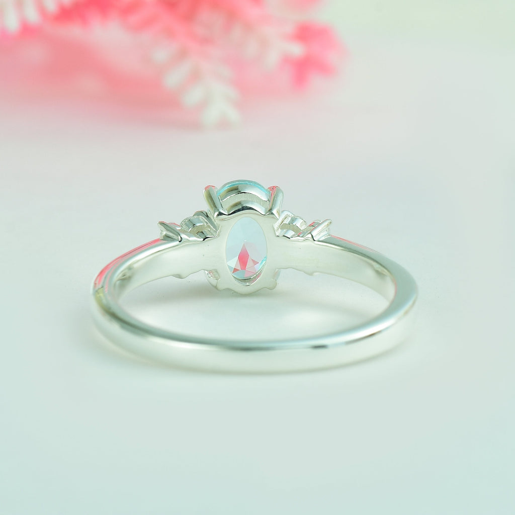 7x5mm Oval Blue Topaz Ring with side Accents - 925 Sterling Silver